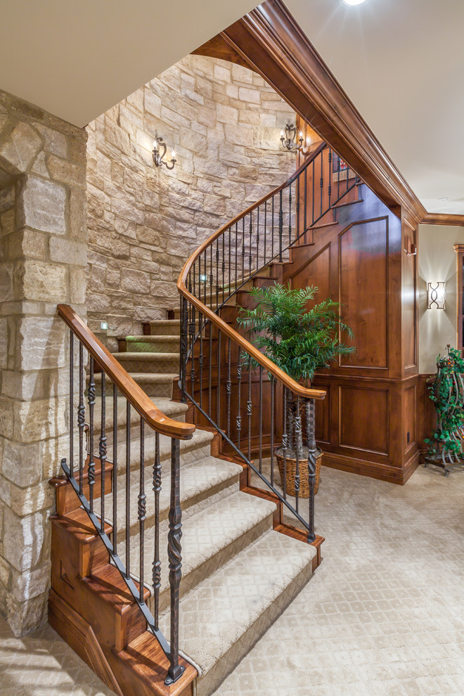 Mountain style wooden curved staircase photo in Denver with wooden risers
