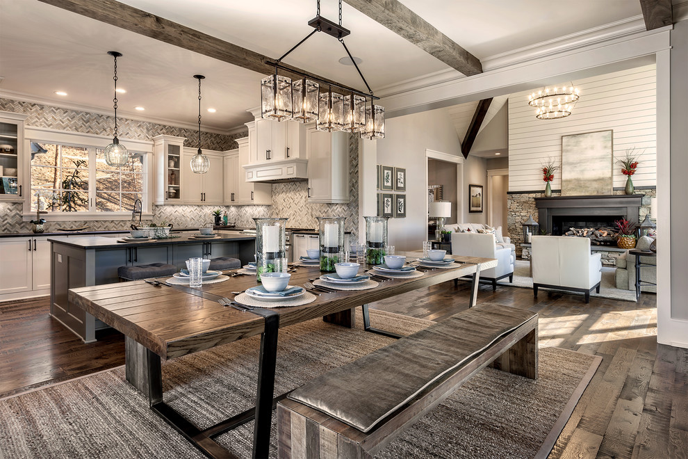 Kitchen/dining room combo - large rustic u-shaped medium tone wood floor kitchen/dining room combo idea with white cabinets, stainless steel appliances and an island