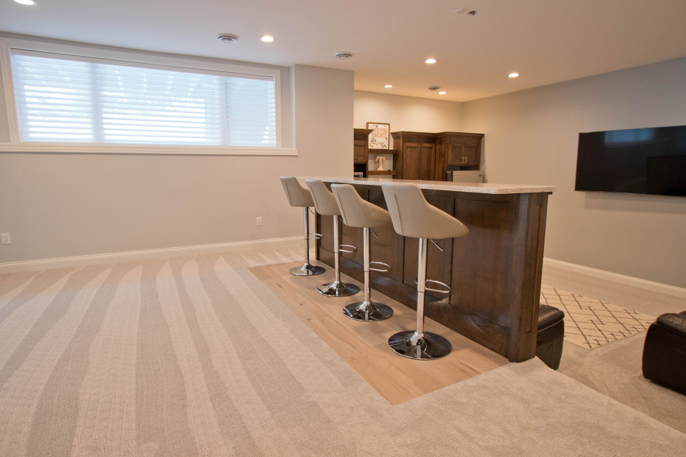 Inspiration for a transitional look-out basement in Other with beige floor, beige walls and light hardwood floors.