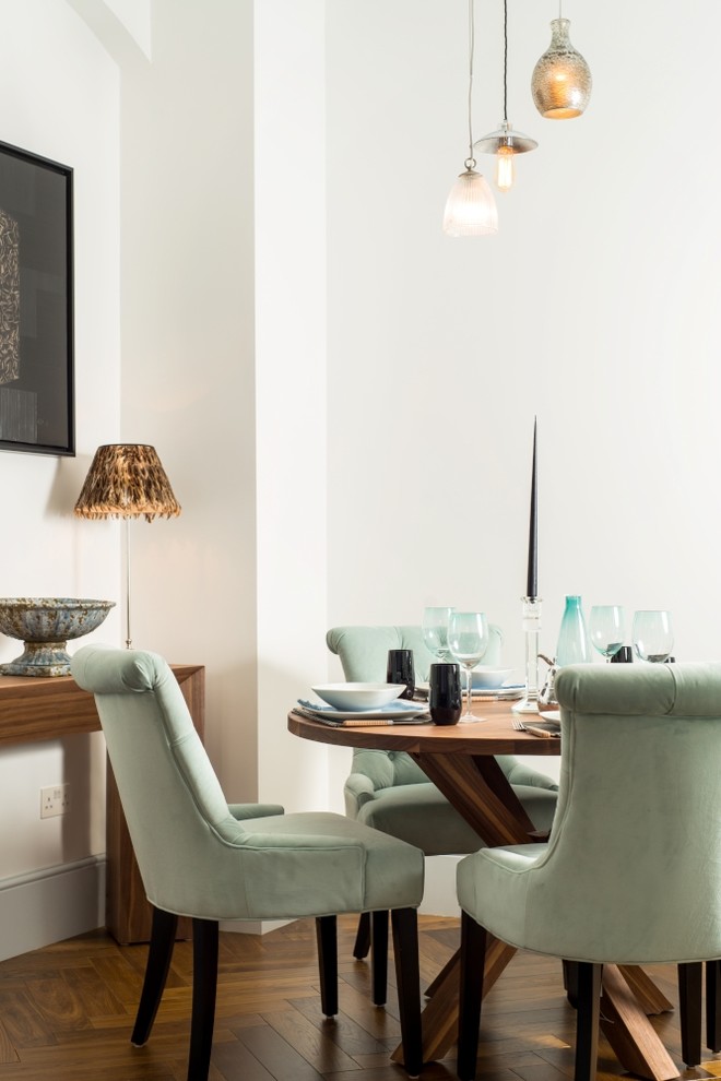 Medium sized contemporary enclosed dining room in London with white walls and dark hardwood flooring.
