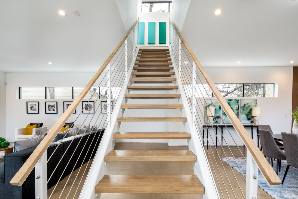 Inspiration for a large modern wood straight staircase in Dallas with open risers and cable railing.