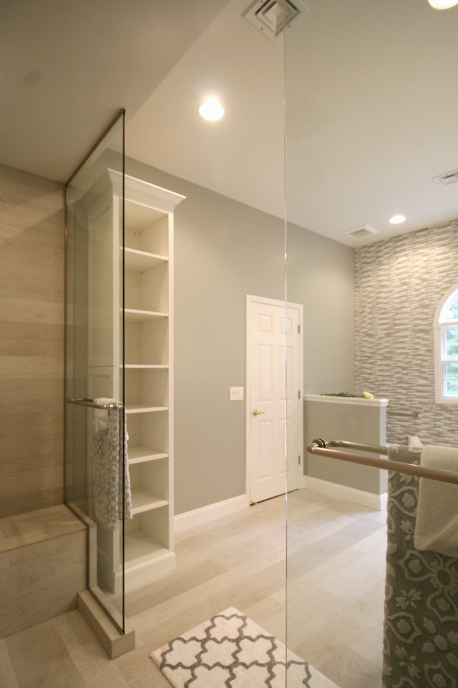 Expansive transitional master bathroom in New York with an undermount sink, white cabinets, a double shower, a bidet, gray tile, porcelain tile, grey walls, recessed-panel cabinets, solid surface benchtops and porcelain floors.