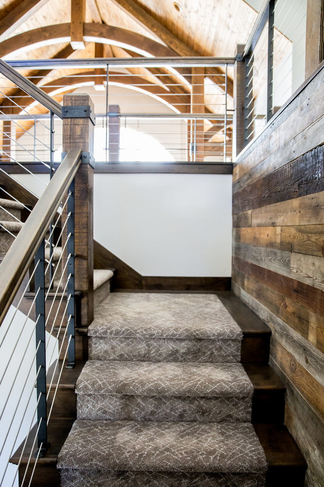 Photo of a mid-sized carpeted l-shaped staircase in Salt Lake City with carpet risers and wood railing.