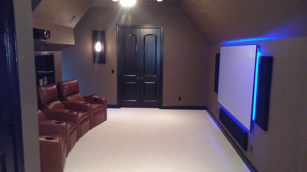 This is an example of a small modern enclosed home theatre in Charlotte with brown walls, carpet and a projector screen.