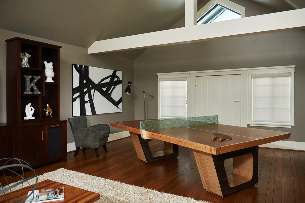 Photo of a large midcentury open concept family room in Los Angeles with a game room, grey walls, medium hardwood floors, no fireplace and brown floor.