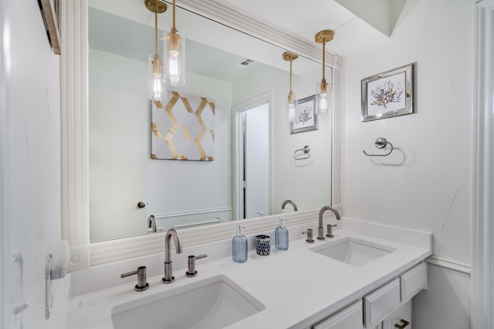 Photo of a small transitional 3/4 bathroom in Dallas with beige cabinets, a drop-in tub, beige tile, an undermount sink, engineered quartz benchtops, a hinged shower door, multi-coloured benchtops, a single vanity, a built-in vanity and decorative wall panelling.