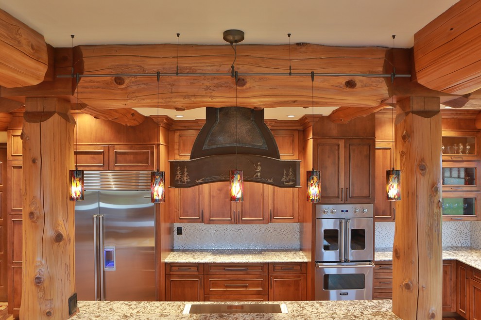 Eat-in kitchen - large rustic l-shaped eat-in kitchen idea with recessed-panel cabinets, medium tone wood cabinets, granite countertops, white backsplash, ceramic backsplash, stainless steel appliances and an island