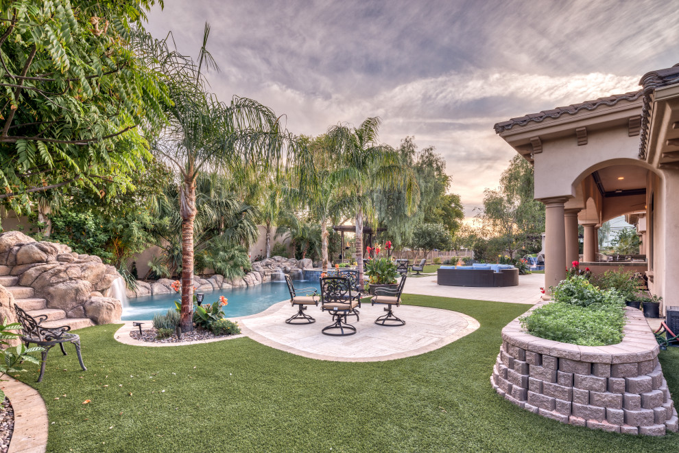 Design ideas for a large contemporary backyard natural pool in Phoenix with with a pool and concrete pavers.