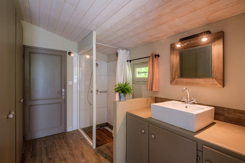 Design ideas for a mid-sized country 3/4 bathroom in Bordeaux with beaded inset cabinets, green cabinets, a corner shower, white tile, porcelain tile, green walls, linoleum floors, a drop-in sink, wood benchtops, beige floor, an open shower, green benchtops, a single vanity, a built-in vanity and timber.