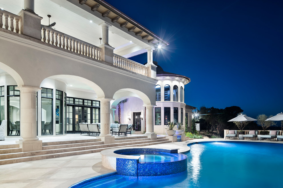 Large transitional backyard infinity pool fountain photo in Austin