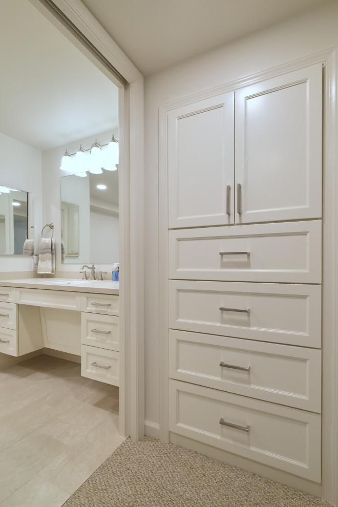 Design ideas for a mid-sized transitional storage and wardrobe in Baltimore with shaker cabinets, white cabinets, ceramic floors and beige floor.