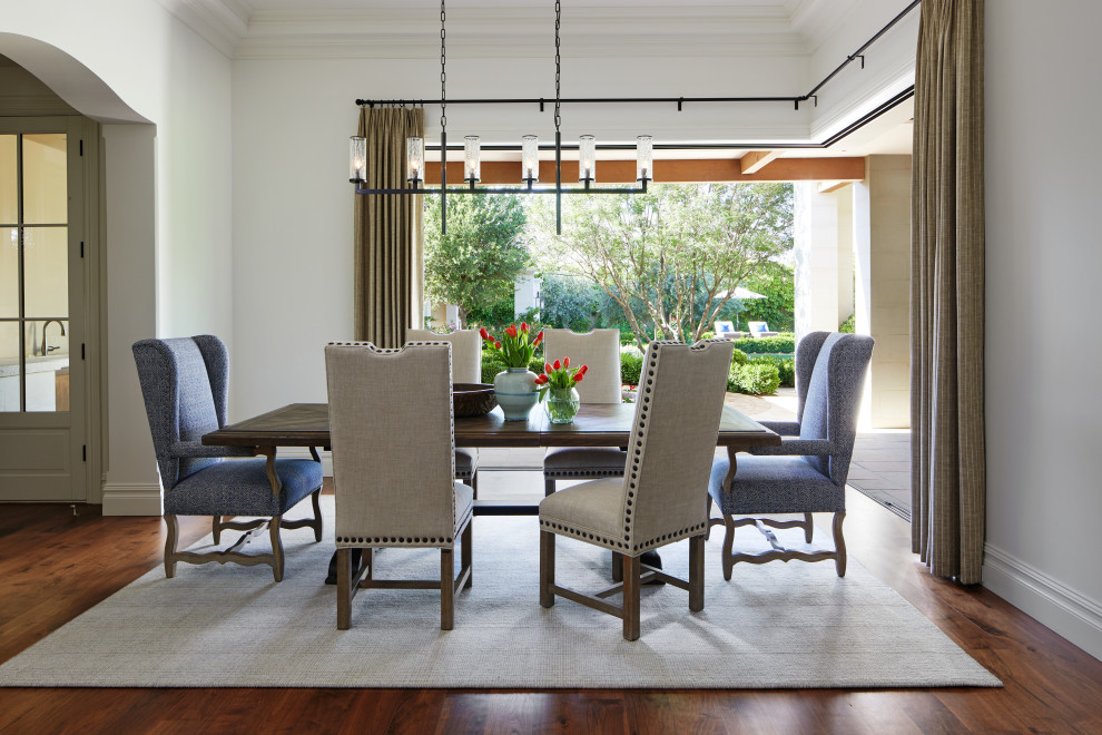 Photo of a large dining room in Phoenix with white walls, dark hardwood floors and brown floor.