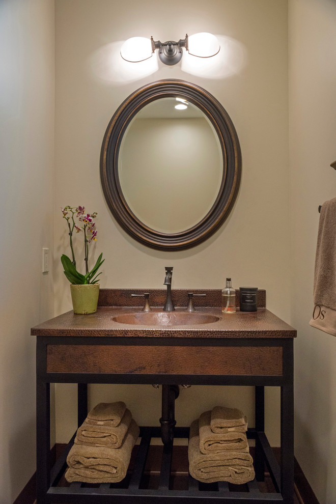 Design ideas for a mid-sized transitional powder room in Los Angeles with beige walls, dark hardwood floors and an undermount sink.