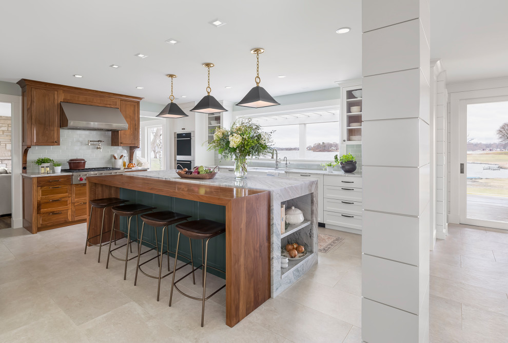 Large transitional porcelain tile and beige floor eat-in kitchen photo in Minneapolis with a farmhouse sink, recessed-panel cabinets, white cabinets, quartzite countertops, ceramic backsplash, stainless steel appliances, an island and white countertops