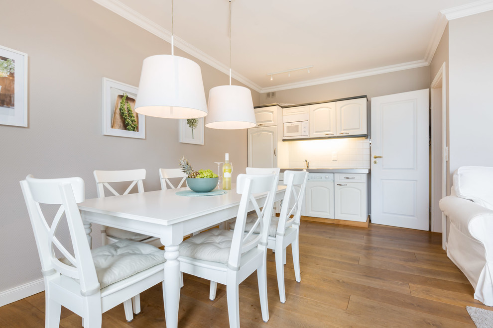 Inspiration for a mid-sized scandinavian dining room in Other with beige walls and medium hardwood floors.
