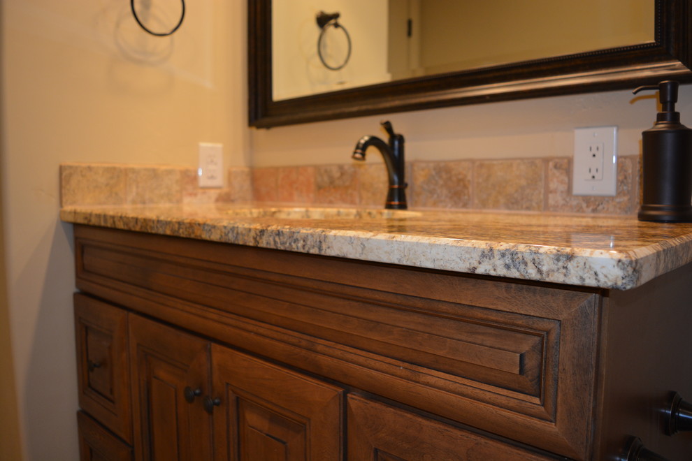 This is an example of a small country 3/4 bathroom in Albuquerque with stone tile and granite benchtops.