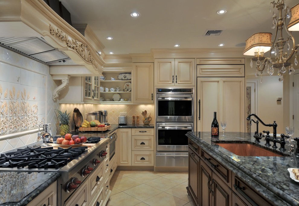 This is an example of a traditional kitchen in New York with an undermount sink, raised-panel cabinets, granite benchtops, stainless steel appliances, ceramic floors, beige cabinets, multi-coloured splashback and ceramic splashback.