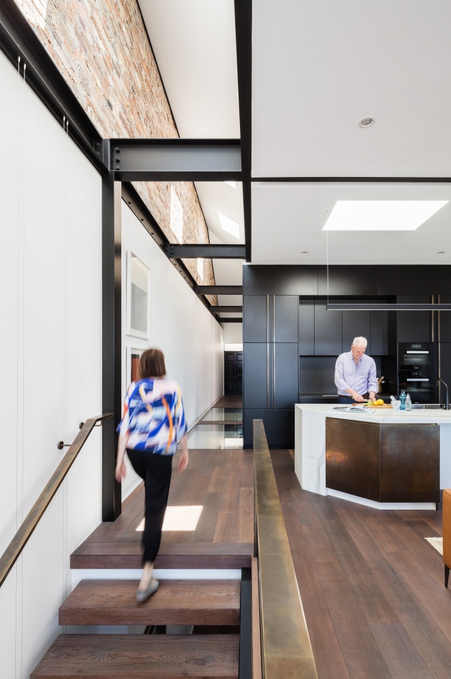 This is an example of a contemporary wood floating staircase in Sydney with open risers.