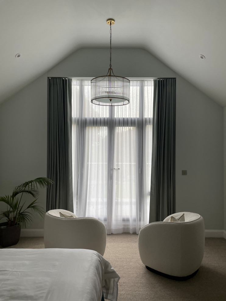Идея дизайна: огромная хозяйская спальня: освещение в стиле модернизм с зелеными стенами, ковровым покрытием и бежевым полом