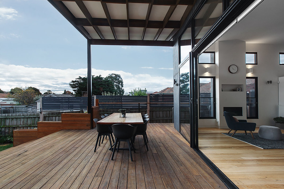 Design ideas for a large contemporary backyard deck in Melbourne with a roof extension.