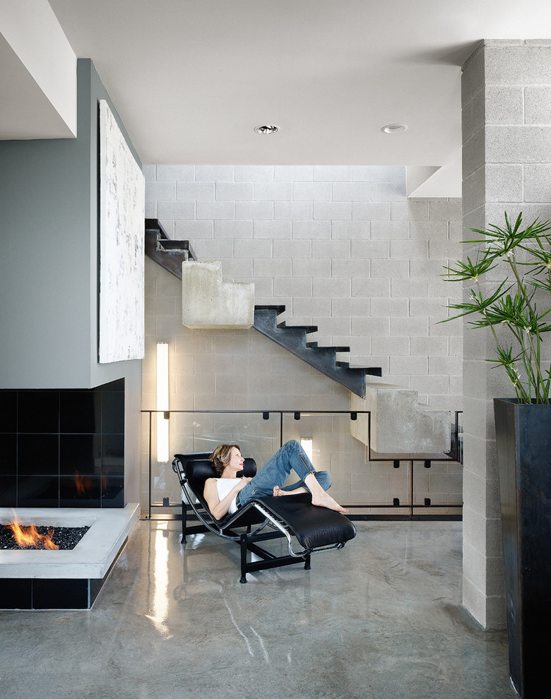 This is an example of a modern living room in Austin with concrete floors.
