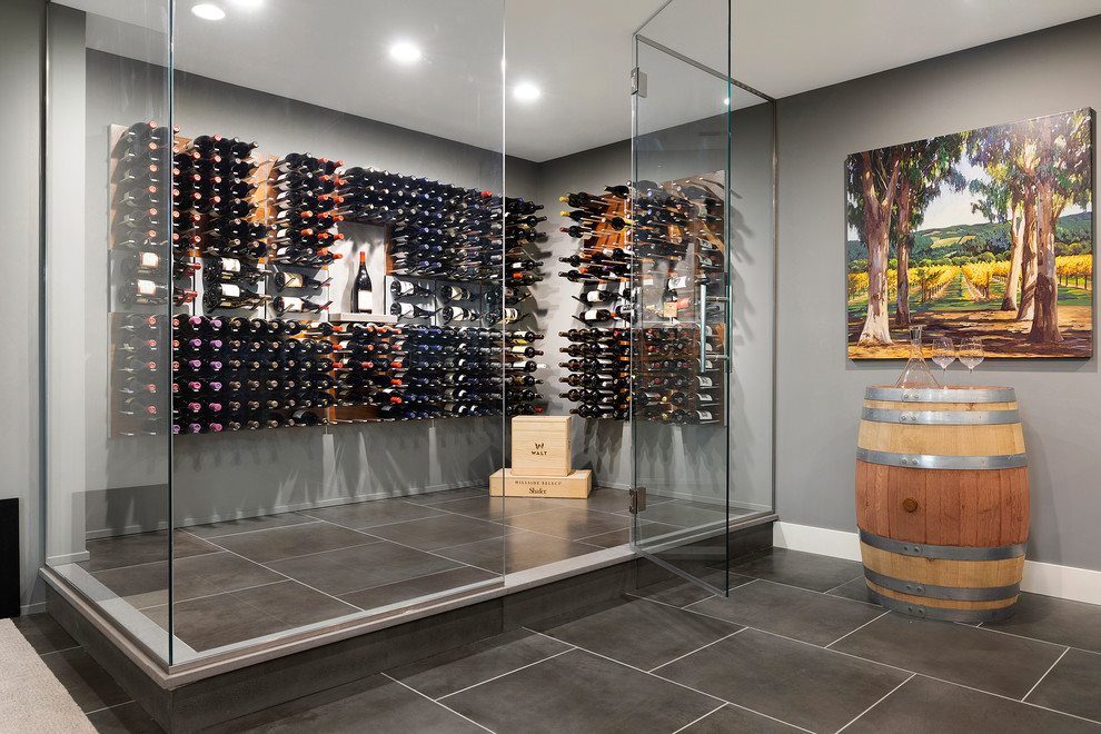 This is an example of a modern wine cellar in Minneapolis with porcelain floors, storage racks and grey floor.