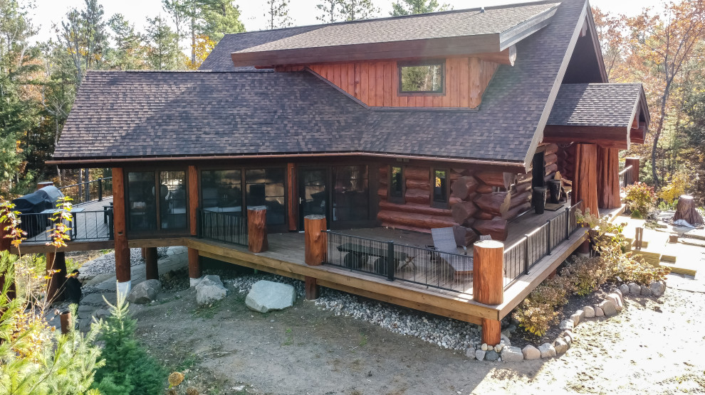Mid-sized rustic brown three-story wood and board and batten gable roof idea with a shingle roof and a brown roof