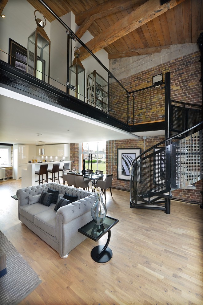 Photo of a large industrial living room in London with light hardwood floors, white walls, no fireplace and no tv.