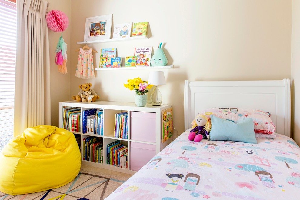 This is an example of a small transitional kids' room for girls in Melbourne with beige walls and carpet.
