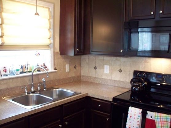 Transitional kitchen photo in Raleigh with granite countertops, multicolored backsplash and ceramic backsplash