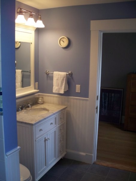 This is an example of a small traditional kids bathroom in Boston with an undermount sink, raised-panel cabinets, white cabinets, granite benchtops, a freestanding tub, a shower/bathtub combo, a two-piece toilet, yellow tile, ceramic tile, blue walls and ceramic floors.