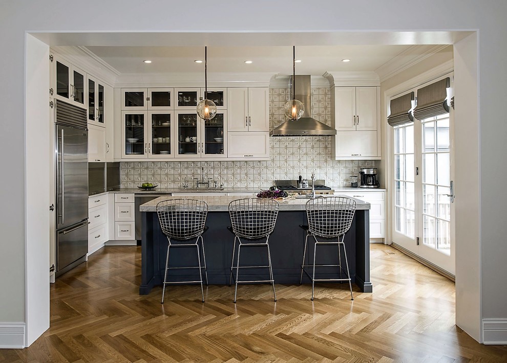 Inspiration for a mid-sized transitional l-shaped medium tone wood floor open concept kitchen remodel in Chicago with an undermount sink, flat-panel cabinets, white cabinets, granite countertops, beige backsplash, stainless steel appliances, an island and mosaic tile backsplash