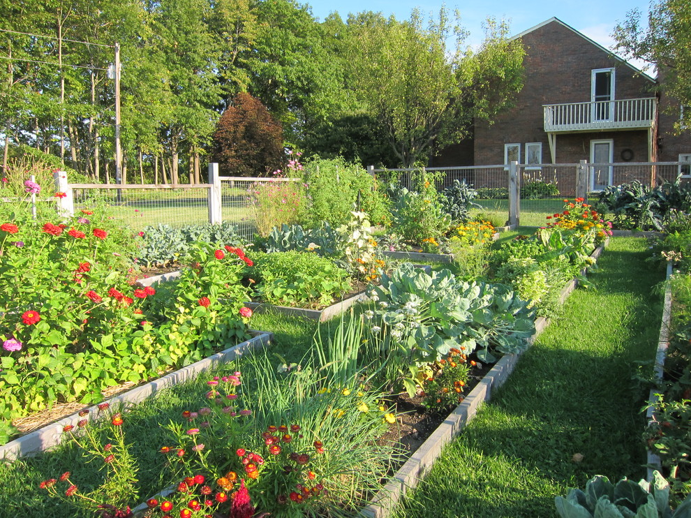 Traditional garden in Burlington with with raised garden bed.