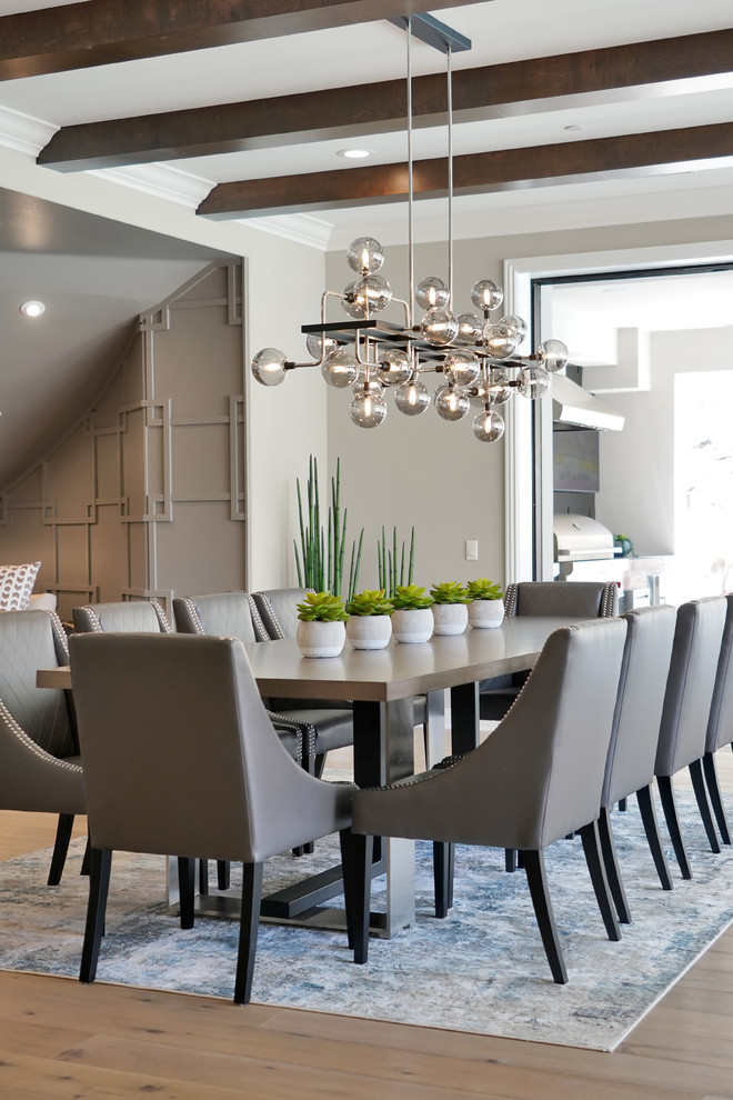 Transitional dining room in Orange County with grey walls, brown floor and light hardwood floors.
