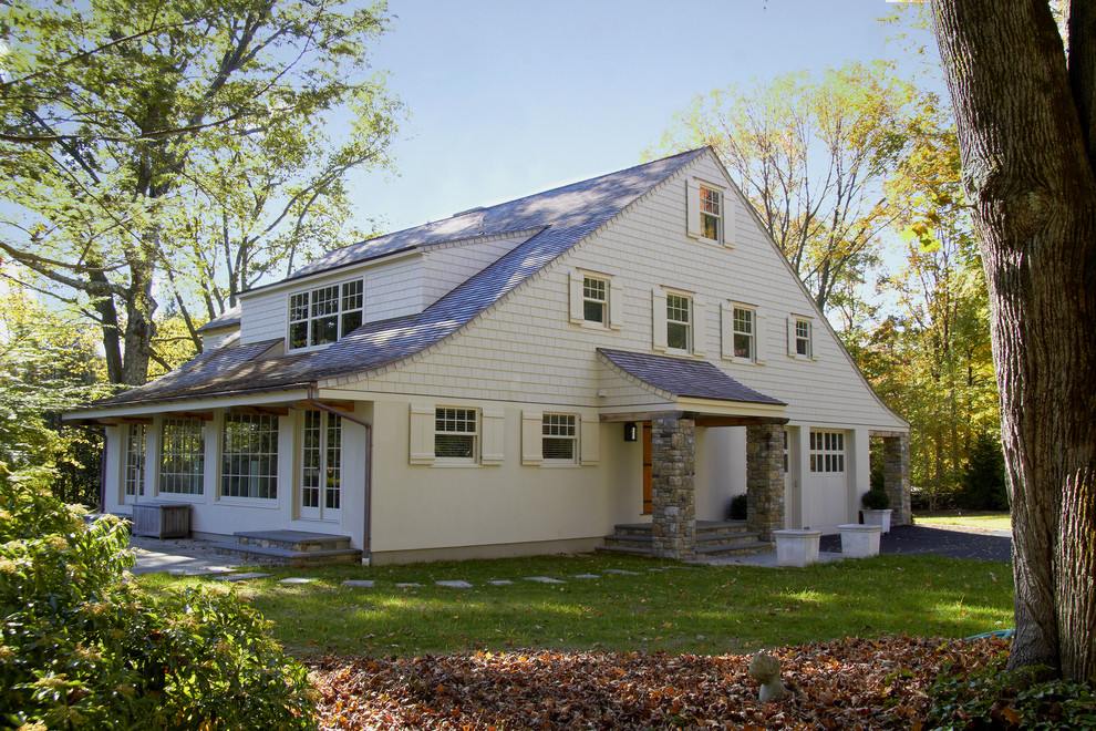 This is an example of a mid-sized traditional two-storey exterior in New York with wood siding.