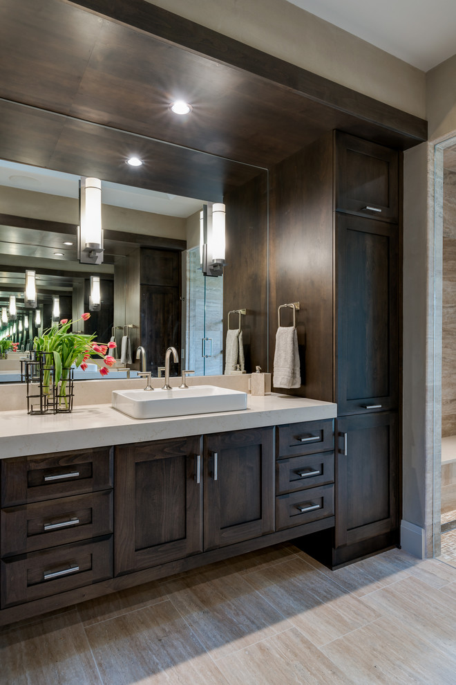 Photo of a large transitional master bathroom in Other with shaker cabinets, dark wood cabinets, a double shower, a one-piece toilet, beige tile, stone tile, beige walls, travertine floors, a vessel sink and engineered quartz benchtops.