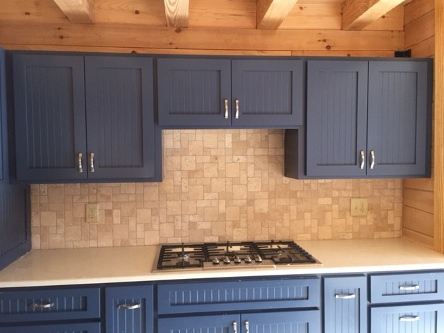 Mid-sized mountain style u-shaped medium tone wood floor and brown floor eat-in kitchen photo with a drop-in sink, recessed-panel cabinets, blue cabinets, granite countertops, beige backsplash, mosaic tile backsplash, stainless steel appliances, an island and beige countertops