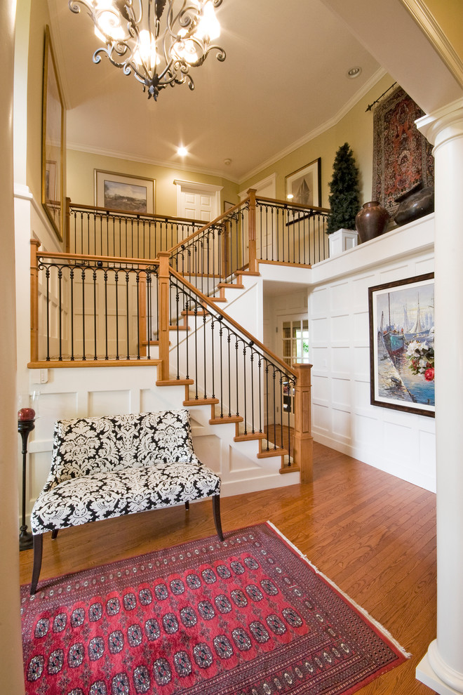 Inspiration for a mid-sized traditional foyer in Vancouver with beige walls, medium hardwood floors, a single front door and a black front door.