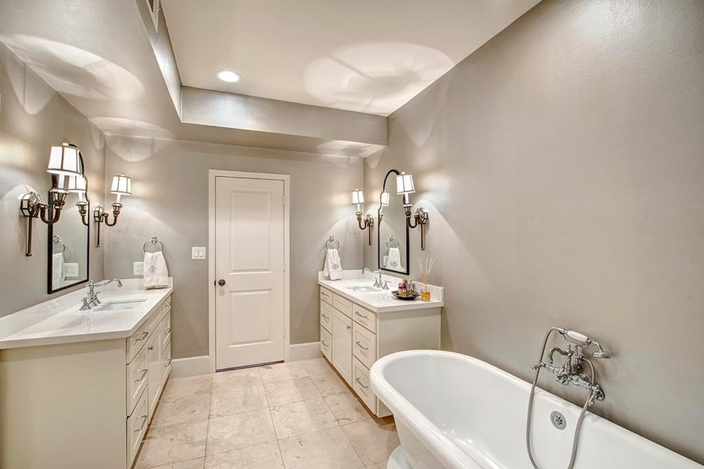 Photo of a mid-sized traditional master bathroom in Houston with recessed-panel cabinets, white cabinets, a freestanding tub, an alcove shower, a two-piece toilet, travertine, grey walls, vinyl floors, an undermount sink, onyx benchtops, brown floor, a hinged shower door and white benchtops.