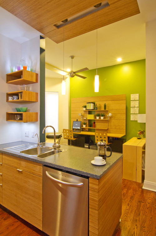 This is an example of a mid-sized contemporary eat-in kitchen in Chicago with an undermount sink, flat-panel cabinets, recycled glass benchtops, green splashback, glass tile splashback, stainless steel appliances and with island.