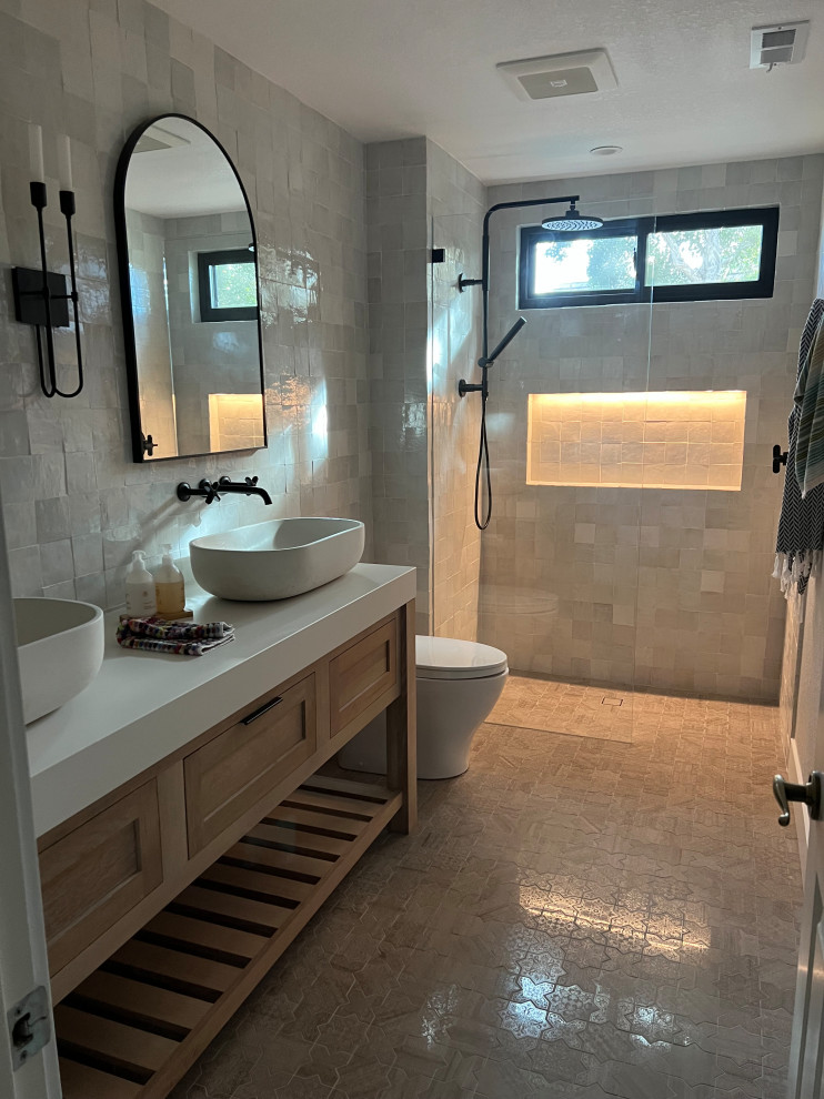 This is an example of a small traditional shower room bathroom in San Francisco with recessed-panel cabinets, light wood cabinets, a built-in shower, a one-piece toilet, beige tiles, ceramic tiles, ceramic flooring, a vessel sink, quartz worktops, beige floors, an open shower, white worktops, a wall niche, double sinks and a freestanding vanity unit.