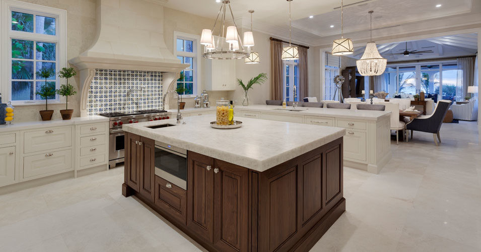 Inspiration for a large transitional u-shaped open plan kitchen in Miami with quartzite benchtops, stainless steel appliances, marble floors, with island, an undermount sink, raised-panel cabinets, white cabinets, blue splashback and glass tile splashback.