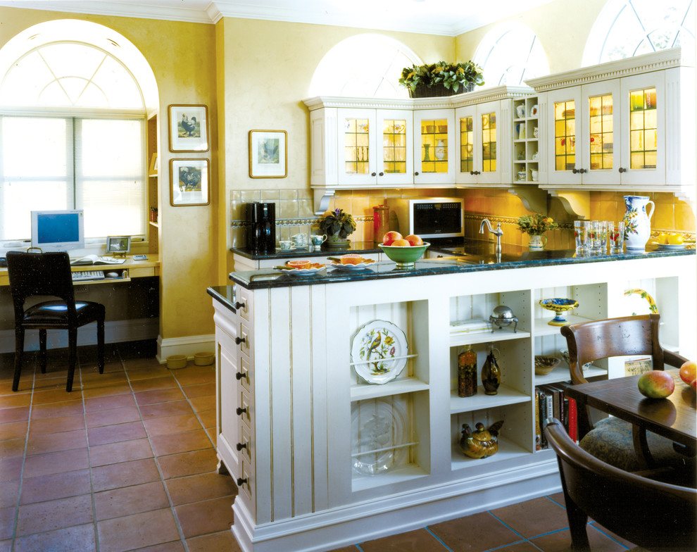 Design ideas for a large mediterranean u-shaped eat-in kitchen in Minneapolis with a drop-in sink, raised-panel cabinets, white cabinets, wood benchtops, yellow splashback, ceramic splashback, terra-cotta floors and a peninsula.