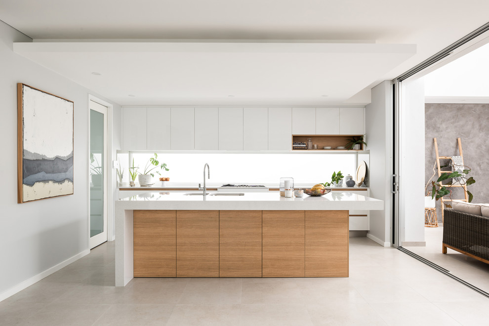 This is an example of a contemporary l-shaped kitchen in Perth with an undermount sink, flat-panel cabinets, white cabinets, white splashback, window splashback, with island, grey floor and white benchtop.