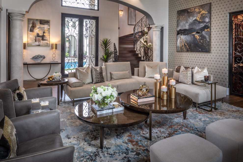 Expansive mediterranean formal open concept living room in Houston with no fireplace, vaulted, wallpaper, grey walls, dark hardwood floors and brown floor.