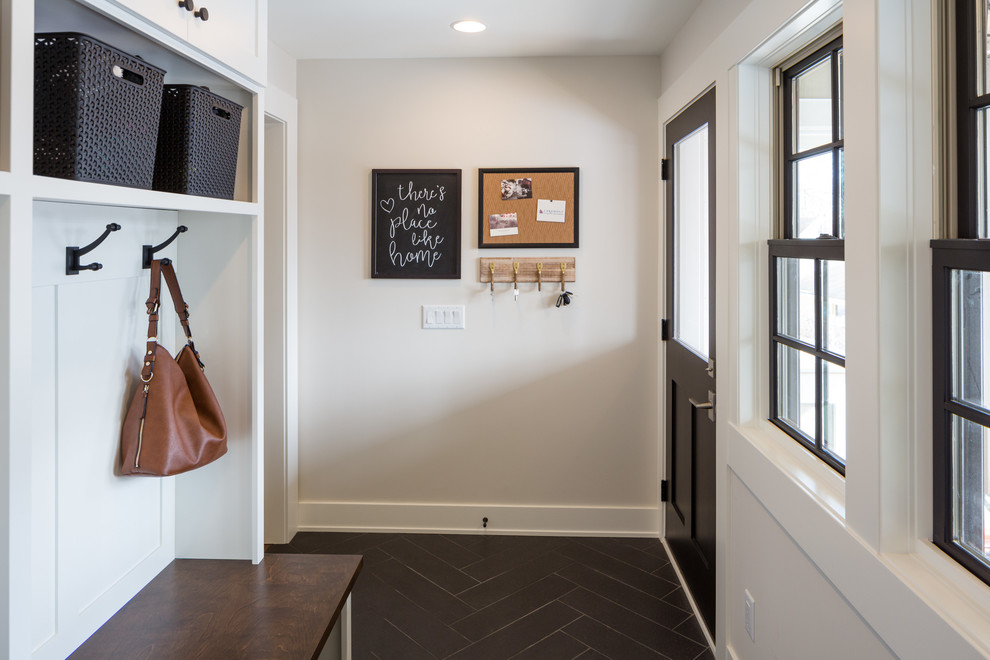 Transitional mudroom in Minneapolis with white walls, a single front door, a black front door and black floor.