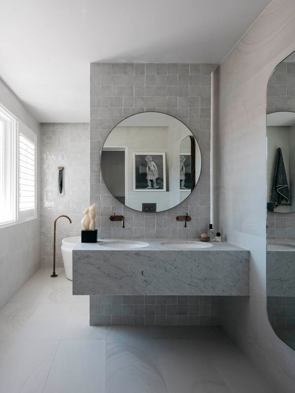 This is an example of a large contemporary 3/4 bathroom in Sydney with grey cabinets, a freestanding tub, an open shower, gray tile, slate, grey walls, slate floors, an integrated sink, marble benchtops, grey floor, an open shower, grey benchtops, a niche, a single vanity and a floating vanity.