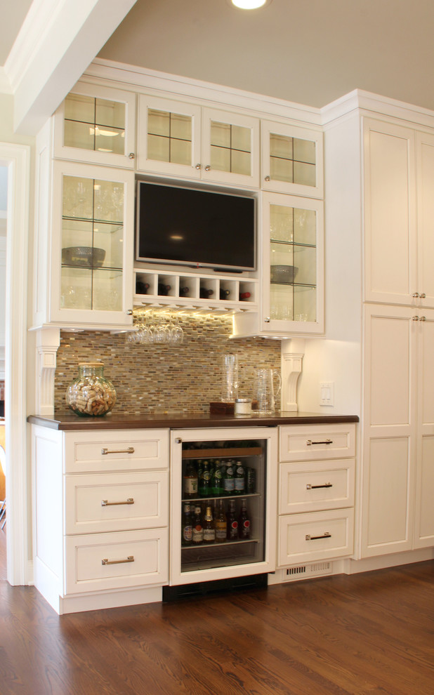This is an example of a small transitional home bar in Other.