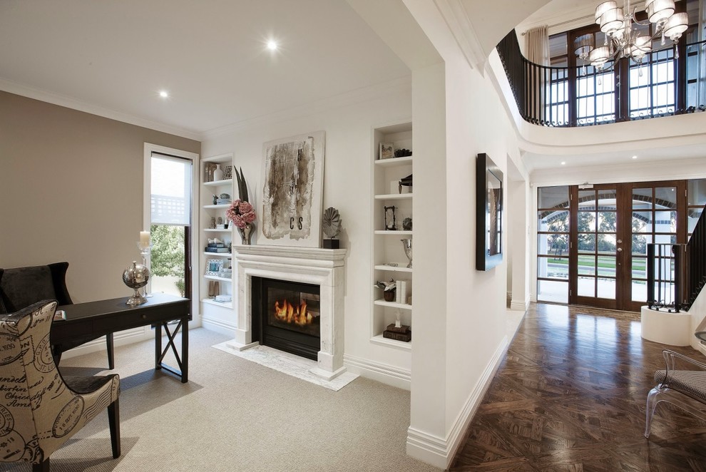 Design ideas for an expansive traditional home office in Melbourne with white walls, medium hardwood floors, a standard fireplace, a stone fireplace surround and a freestanding desk.