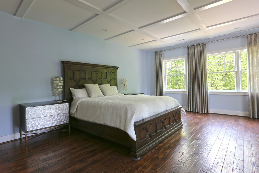 Large country master bedroom in DC Metro with blue walls, dark hardwood floors, no fireplace and brown floor.